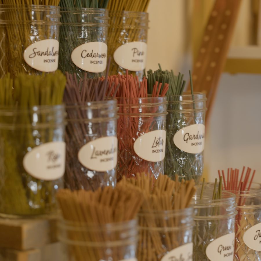 Labeled jars of incense sticks by scent