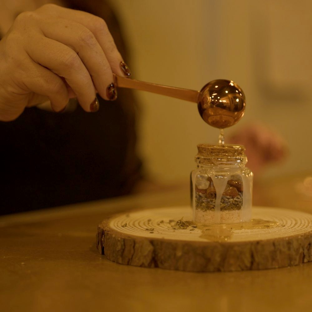 Sealing a spell jar with wax in The Magick Lab